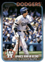 Shohei Ohtani 2024 Topps Update Baseball Series Mint Card #US123 Japanese Born HR Record Ohtani Stands Alone picturing him in his new White Los Angeles Dodgers Jersey
